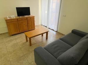 a living room with a couch and a tv at Valthi in La Restinga