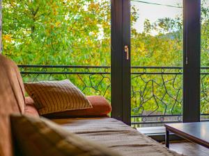 a living room with a couch and a glass door at Chata Geruša in Čebovce +7 photos