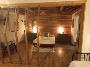 a bedroom with a bed in a room with wooden walls at Sete Cidades Nature Villa in Sete Cidades