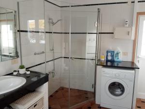 a bathroom with a shower and a washing machine at HelgaHome in Las Breñas +7 photos