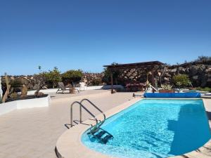 a swimming pool in the middle of a resort at HelgaHome in Las Breñas