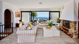 a living room with a dog laying on a couch at Villa El Capricho in Mijas