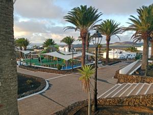 a view of a resort with palm trees at HelgaHome in Las Breñas