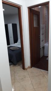 a room with a door leading to a bedroom at White Apartment in Bîrlad