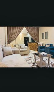 a living room with two couches and a table at Nile palace apartment in Luxor
