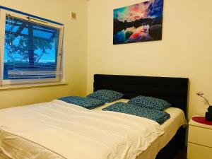 a bedroom with a bed with two pillows on it at COZY ROOM - between Malmö & Lund in Lund