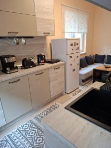 a kitchen and living room with a white refrigerator at Apartament Sofia in Sofia