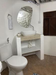 a bathroom with a white toilet and a sink at Pousada Nosso Sonho in Natal +48 photos