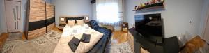 a living room with a bed and a television at Apartament Sofia in Sofia