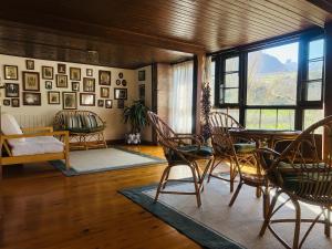 a living room with a table and chairs and a window at Casa Caiceda in Poo de Cabrales