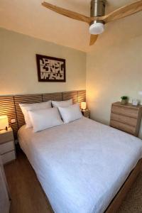 a bedroom with a large bed with white pillows at Sakura Seaside -Expérience Japonaise en bord de mer in Argelès-sur-Mer
