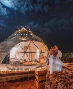 a bride and groom standing in front of a yurt at RUM KANARA BUBBLE lUXURY CAMP in Wadi Rum