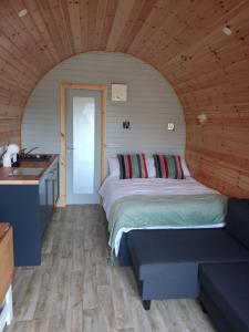 a bedroom with a bed and a sink in a room at Hilltop Glamping in Ardara