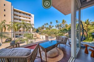 a balcony with a table and chairs and a view at 2BR Condo with Rooftop Pool - 2 Min Walk to Beach in Bucerías