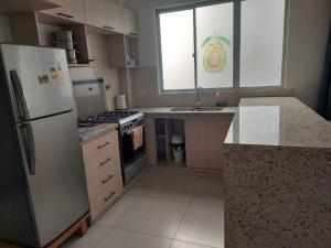 a kitchen with a stainless steel refrigerator and a sink at Libertad in Tarija +4 photos