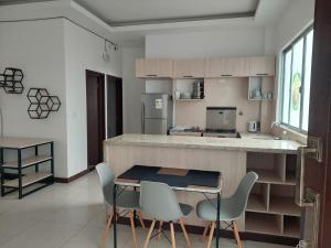a kitchen with a counter and a table and chairs at Libertad in Tarija