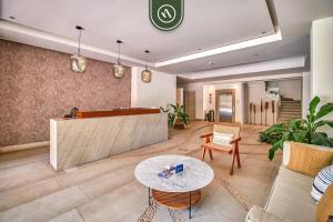 a living room with a couch and a table at 2BR Condo with Rooftop Pool - 2 Min Walk to Beach in Bucerías +34 photos