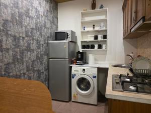 a kitchen with a washing machine and a washer at Urban House in Batumi