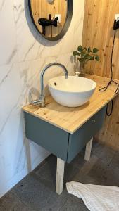 a bathroom sink with a white bowl on a wooden counter at Sete Cidades Nature Villa in Sete Cidades +32 photos