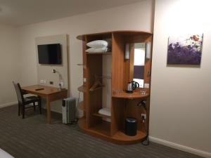 a room with a room with a desk and a room with a room at Charter Hotel Bournemouth in Bournemouth