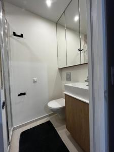 a bathroom with a toilet and a sink and a mirror at Studio moderne Arcueil in Arcueil +3 photos