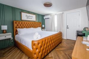 a bedroom with a large bed with a wooden headboard at Chalet 239-Boutique Hotel in West Dover