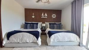a bedroom with two beds with sails on the wall at Condo/ Depa - Marea Azul - Playa del Carmen in Playa del Carmen +63 photos