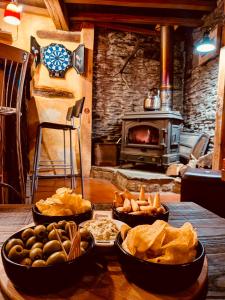 a table with three bowls of food and a stove at La Vieille Forge B&B in Houffalize