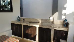 a kitchen with a sink and a counter top at Palm Residence Vacation Villa in Nungwi