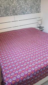 a bed with a colorful comforter on top of it at Green Garden in Gajac