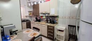 a small kitchen with a table and a counter top at Casa 2000 Positivo UTFPR INC Volvo in Curitiba