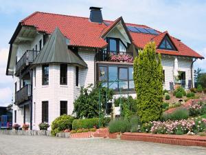 a large white house with a red roof at Ferienwohnung in Madfeld in Madfeld