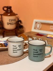 two coffee mugs sitting on top of a counter at Cozy Studio Apartment Pale in Pale