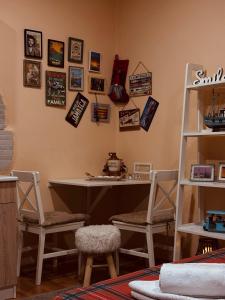a room with a desk and chairs and pictures on the wall at Cozy Studio Apartment Pale in Pale