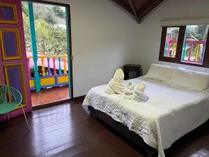 a bedroom with a bed with angel wings on it at Finca Hotel Mariangel in El Peñol +78 photos