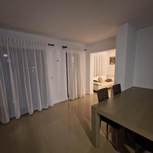 a living room with a table and a couch at Viilor Panoramic in Baia Mare