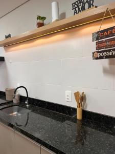 a kitchen with a sink and a counter top at Boa Vista · Amplo Ap. a 5 km do Hospital Regional Hans Dieter in Joinville