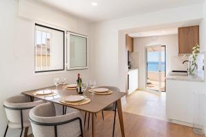 a dining room with a table and chairs and a kitchen at Villa Perdices in Fuengirola +13 photos