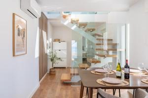a dining room with a table with wine glasses at Villa Perdices in Fuengirola