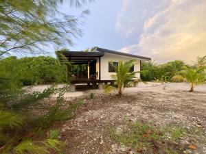 a small house with a black roof at Rangiroa Reef Lodge in Rangiroa