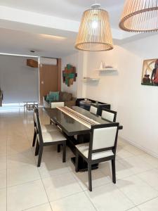 a dining room with a table with chairs and a keyboard at Cabildo Apart Familiar in Santiago del Estero