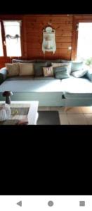 a blue couch with pillows on it in a room at studio in Puessans