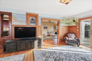 a living room with a flat screen tv on a entertainment center at Coastal Craftsman in Pacific City