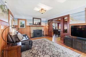 a living room with a television and a fireplace at Coastal Craftsman in Pacific City +62 photos