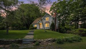 a house with its lights on in the yard at Shoals View Escape Ocean Views Dog-Friendly in Rye