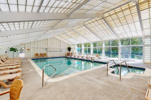 a large indoor pool with a large glass ceiling at Loon Landing at Rivergreen in Lincoln