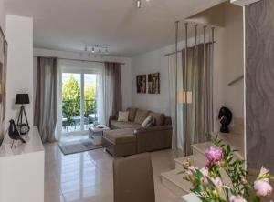 a living room with a couch and a large window at Villa Anita in Gruda