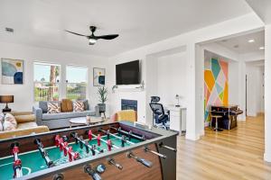 a living room with a foosball table at Indio Access Vacation Home in Indio