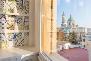 a window with a view of a building at Aurum Pompei Suites in Pompei +67 photos