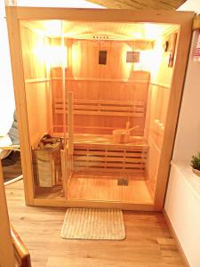 a small cage in a room with a wooden floor at Ferienwohnung Schusternagerl in Simbach +18 photos